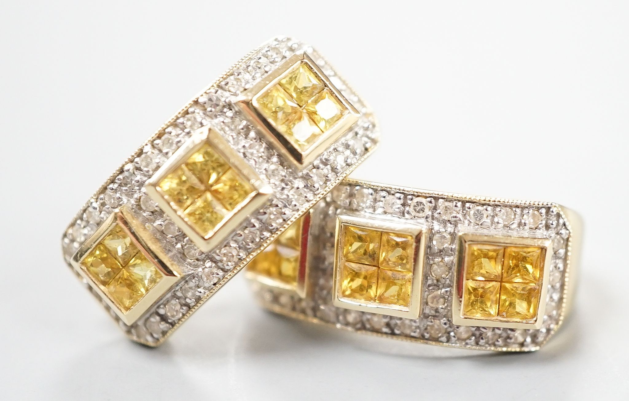 A modern pair of 14k yellow metal, diamond chip and triple cluster yellow sapphire? set half hoop earrings, 19mm, gross weight 6.9 grams.